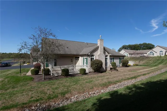 a view of a house with backyard and porch