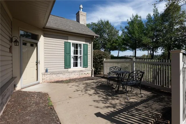 a view of a street sign under a large tree