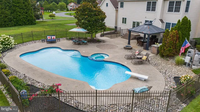 a view of a big house with a big yard and large trees