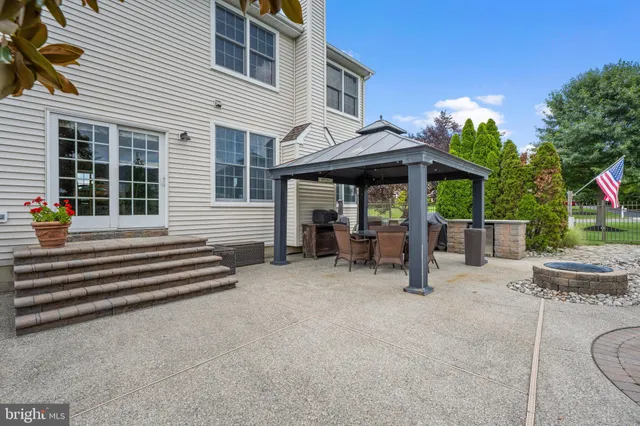 a view of a swimming pool with a patio and a yard