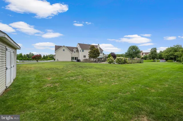 a view of a swimming pool with chairs in patio