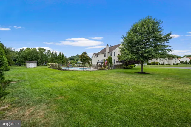 a spacious bedroom with a bed and a chandelier