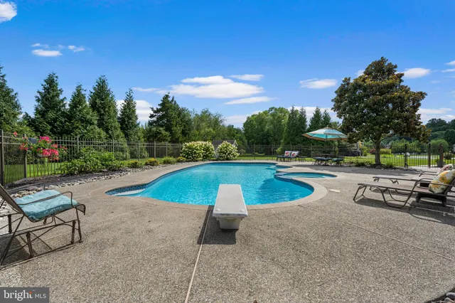 a view of a hallway with wooden floor and stairs
