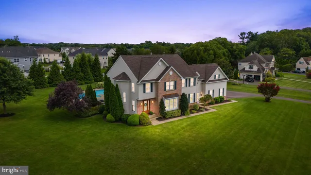 a view of a house with garden and a car park