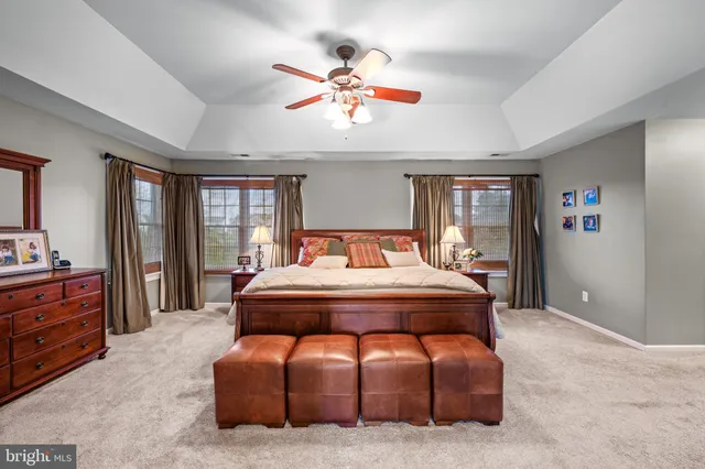 a dining room with furniture a chandelier and wooden floor