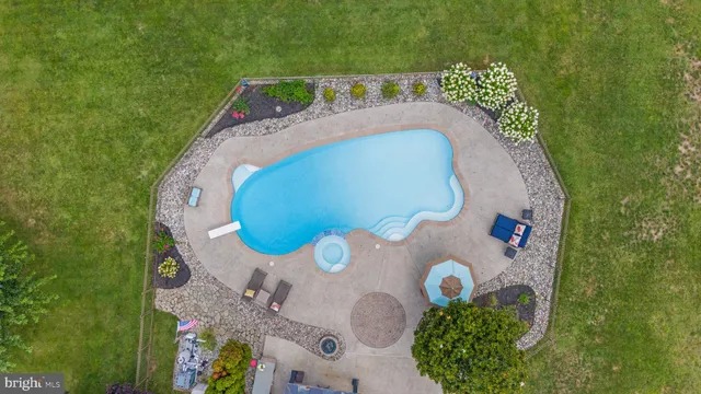 an aerial view of a house with garden space and street view