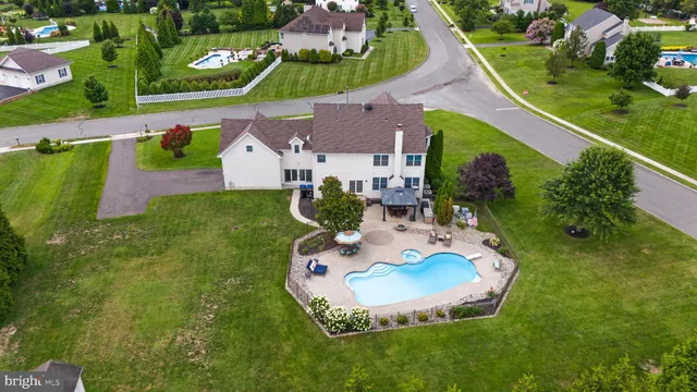 an aerial view of a city with lots of residential buildings ocean and mountain view in back