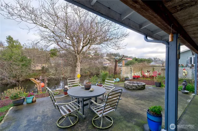 a view of a patio with chairs and potted plants