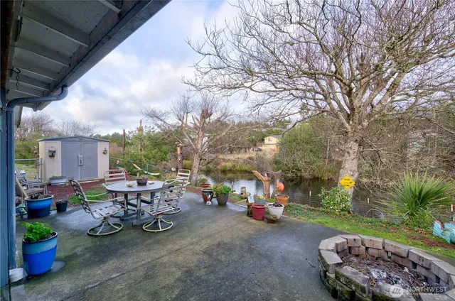 a view of a patio with table and chairs and potted plants