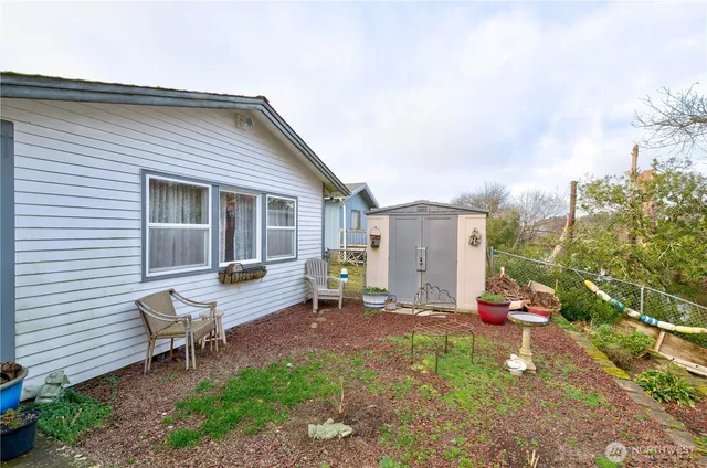a backyard of a house with table and chairs