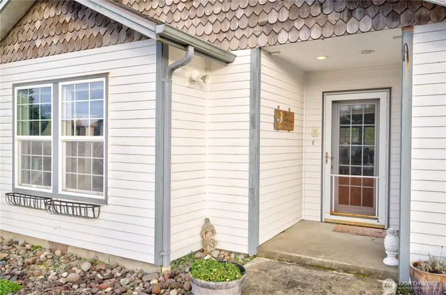 a view of a house with a potted plant and a window