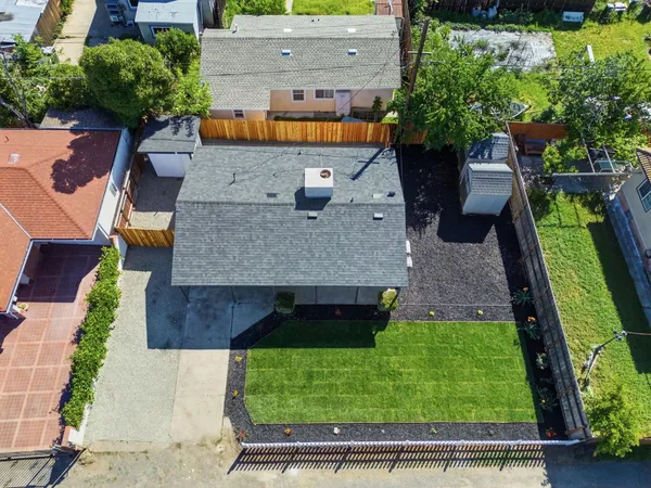 an aerial view of a house with a yard
