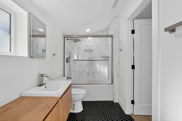 a bathroom with a sink toilet and shower