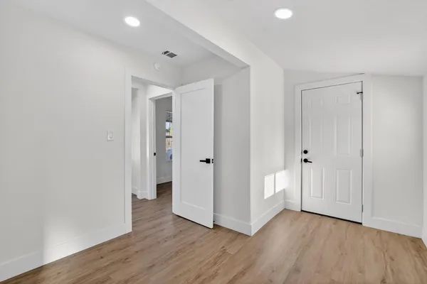 a view of a hallway with wooden floor