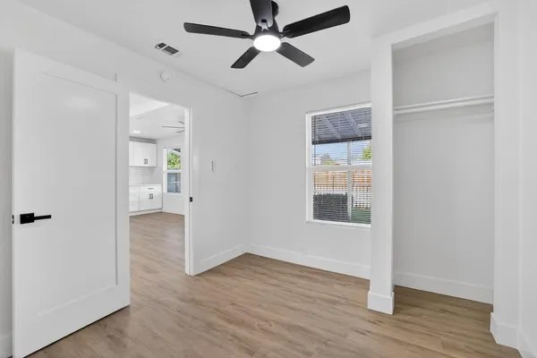 wooden floor in an empty room with a window
