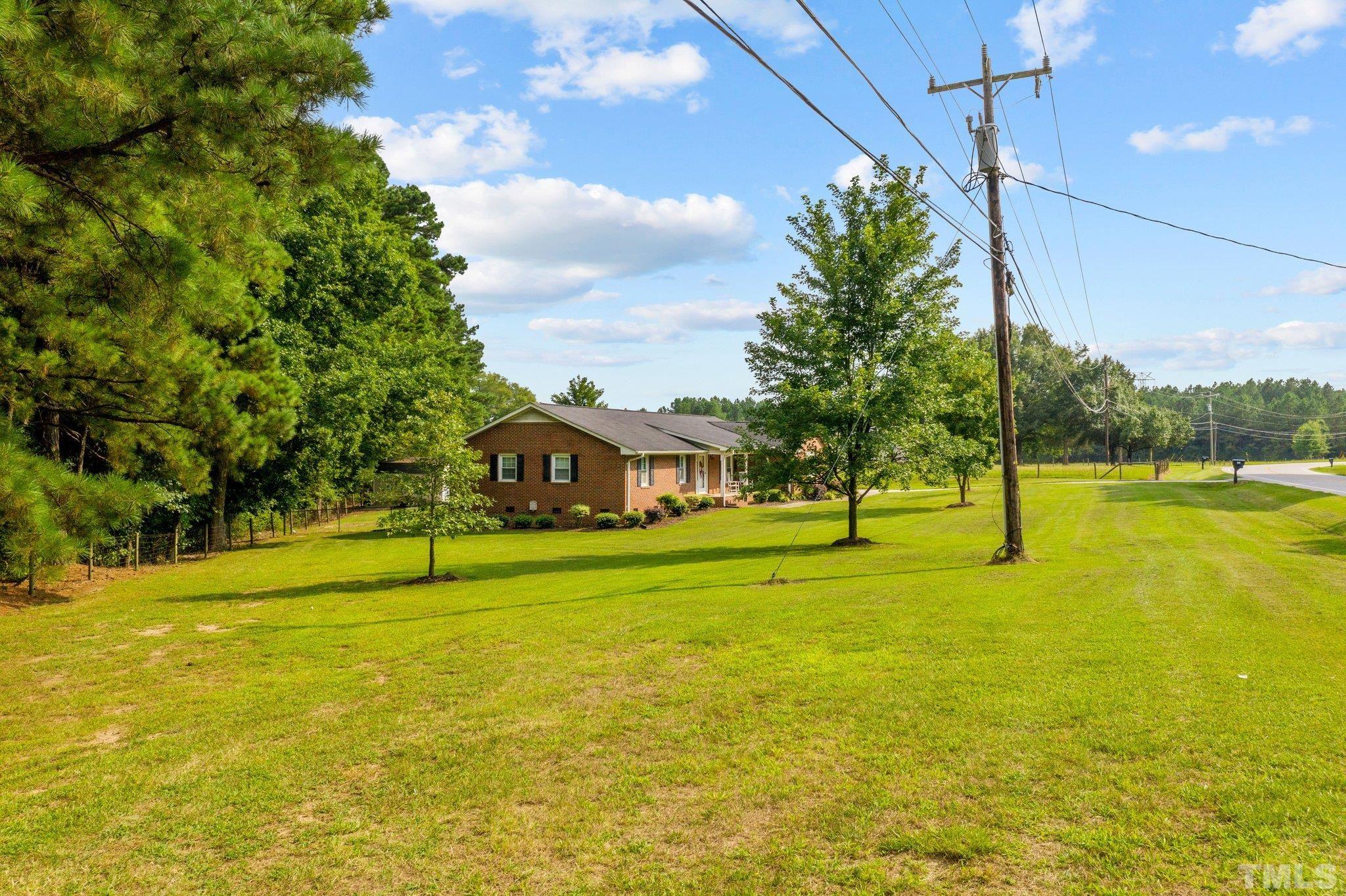 705 Sherron Road Durham, NC 27703 - Photo 2 of 28 a yellow house with swimming pool in front of it
