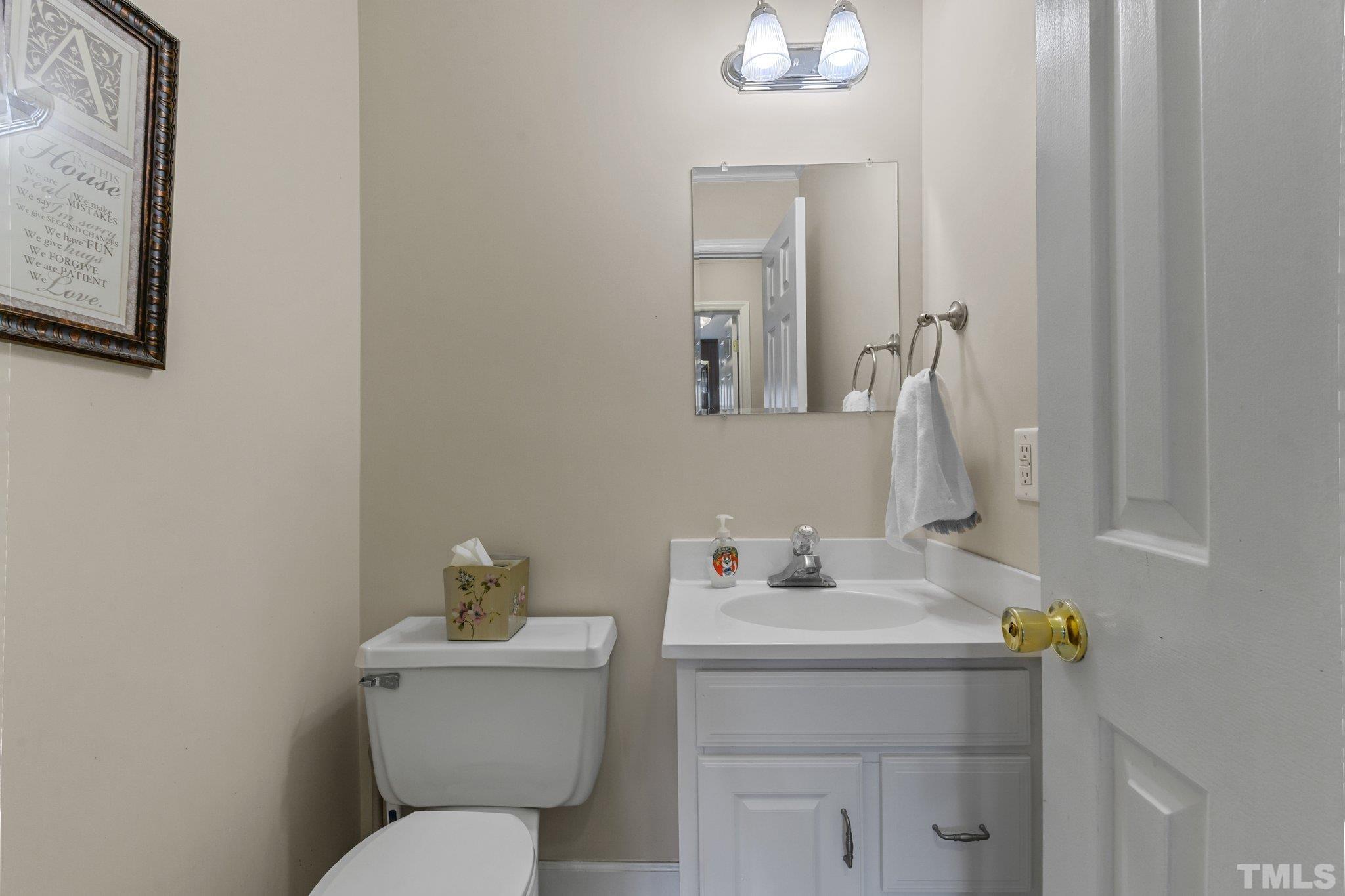 705 Sherron Road Durham, NC 27703 - Photo 14 of 28 a bathroom with a sink mirror and toilet