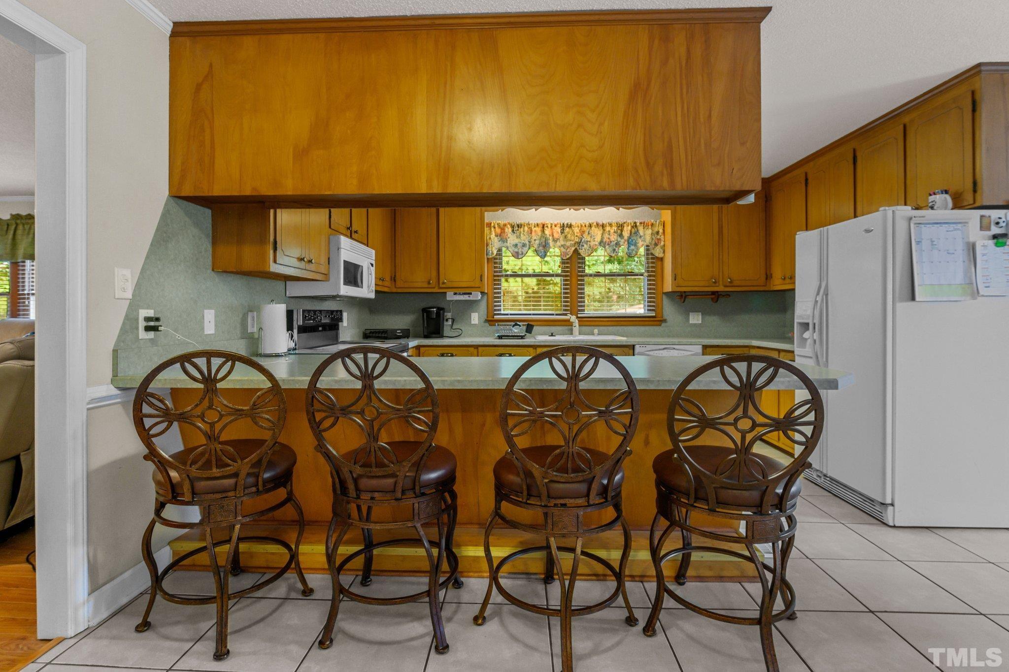 705 Sherron Road Durham, NC 27703 - Photo 15 of 28 a view of a dining room with furniture and window