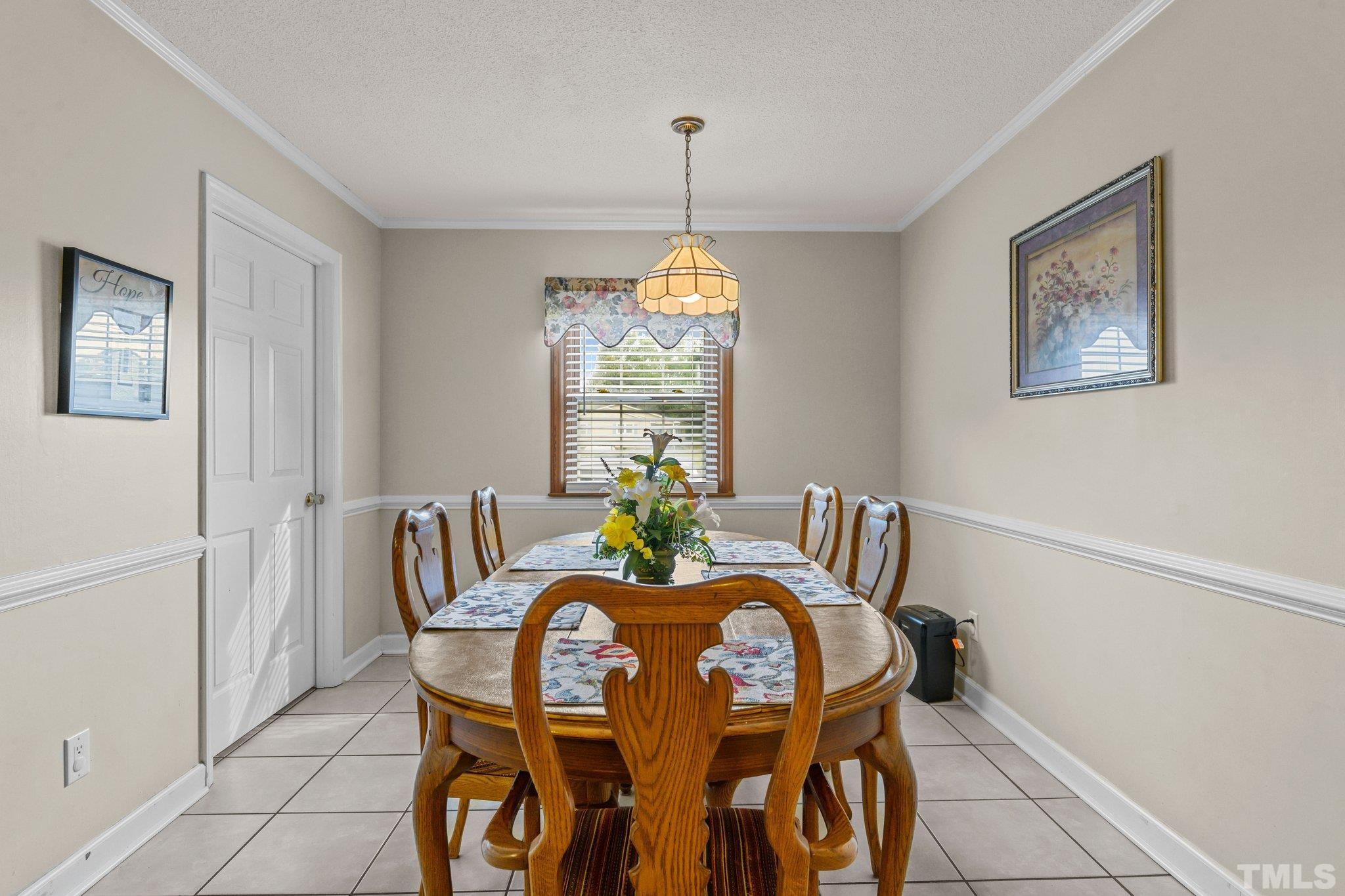 705 Sherron Road Durham, NC 27703 - Photo 16 of 28 a view of a dining room with furniture window and wooden floor
