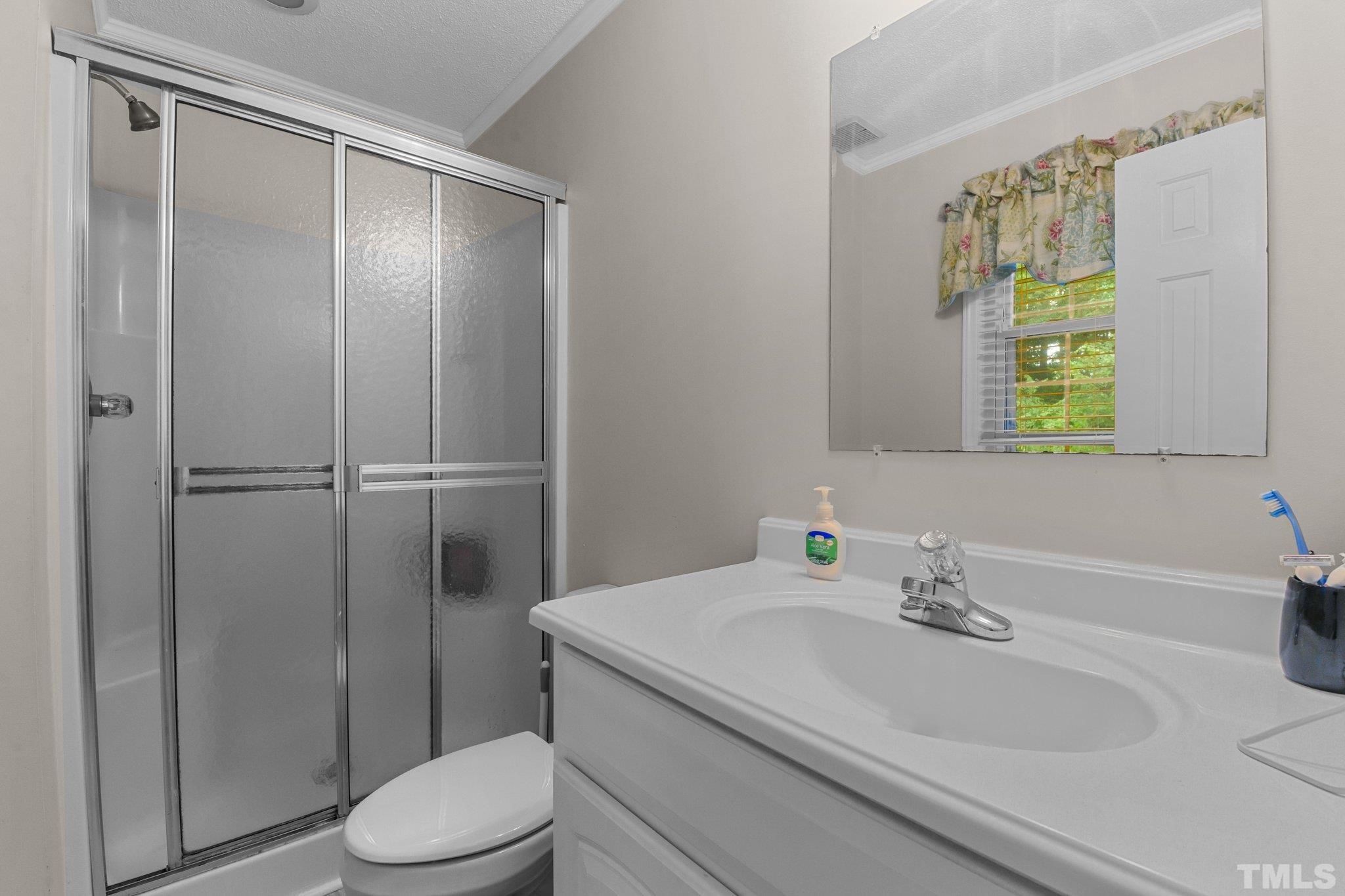 705 Sherron Road Durham, NC 27703 - Photo 18 of 28 a bathroom with a sink toilet and shower