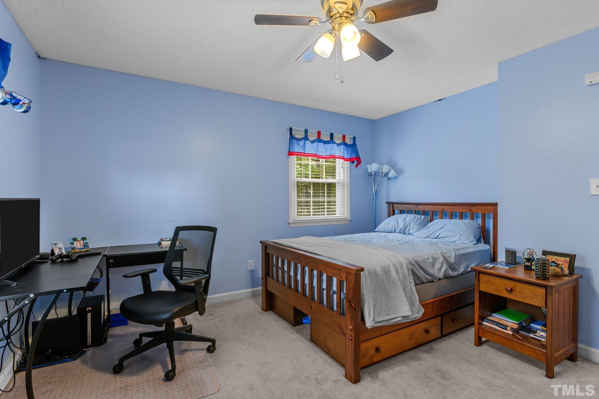 705 Sherron Road Durham, NC 27703 - Photo 21 of 28 a bedroom with a bed and a chandelier
