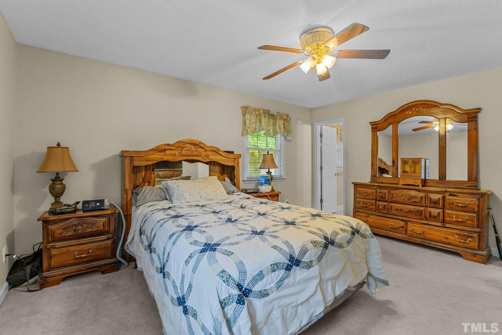 705 Sherron Road Durham, NC 27703 - Photo 23 of 28 a bedroom with a bed and a chandelier