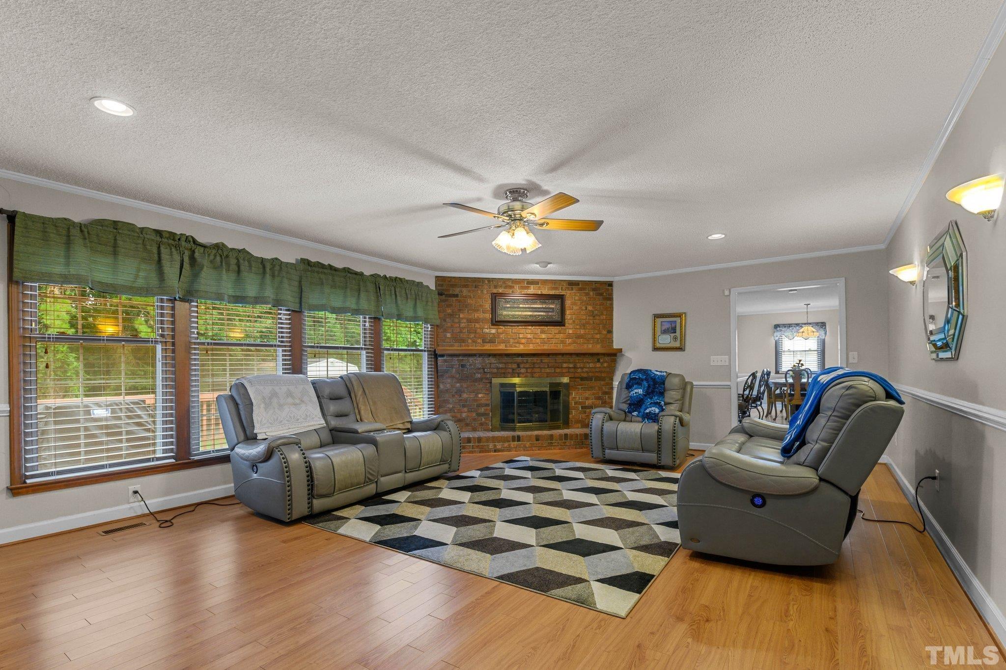 705 Sherron Road Durham, NC 27703 - Photo 24 of 28 a living room with fireplace furniture and a wooden floor