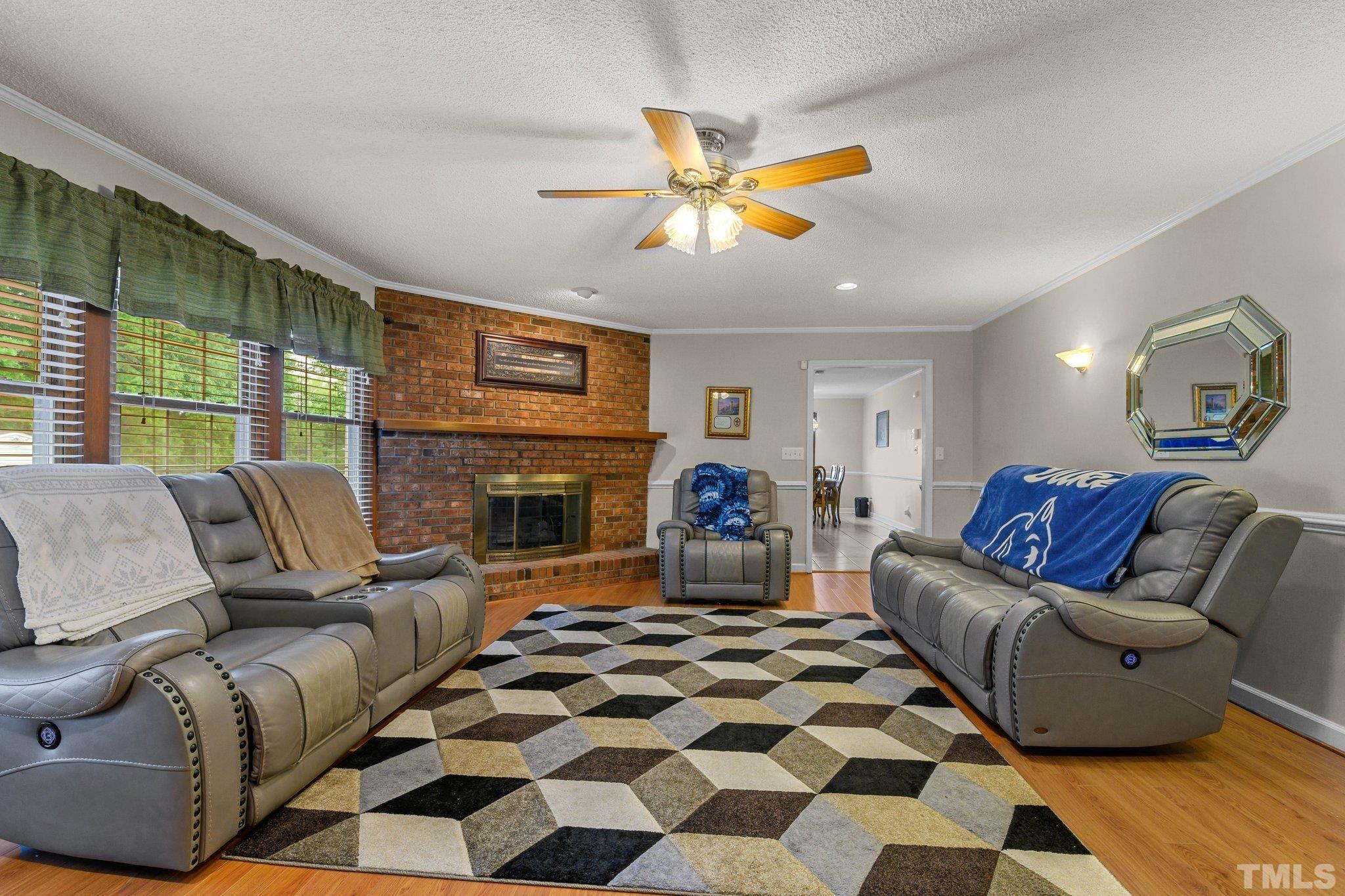 705 Sherron Road Durham, NC 27703 - Photo 25 of 28 a living room with furniture a flat screen tv and a fireplace