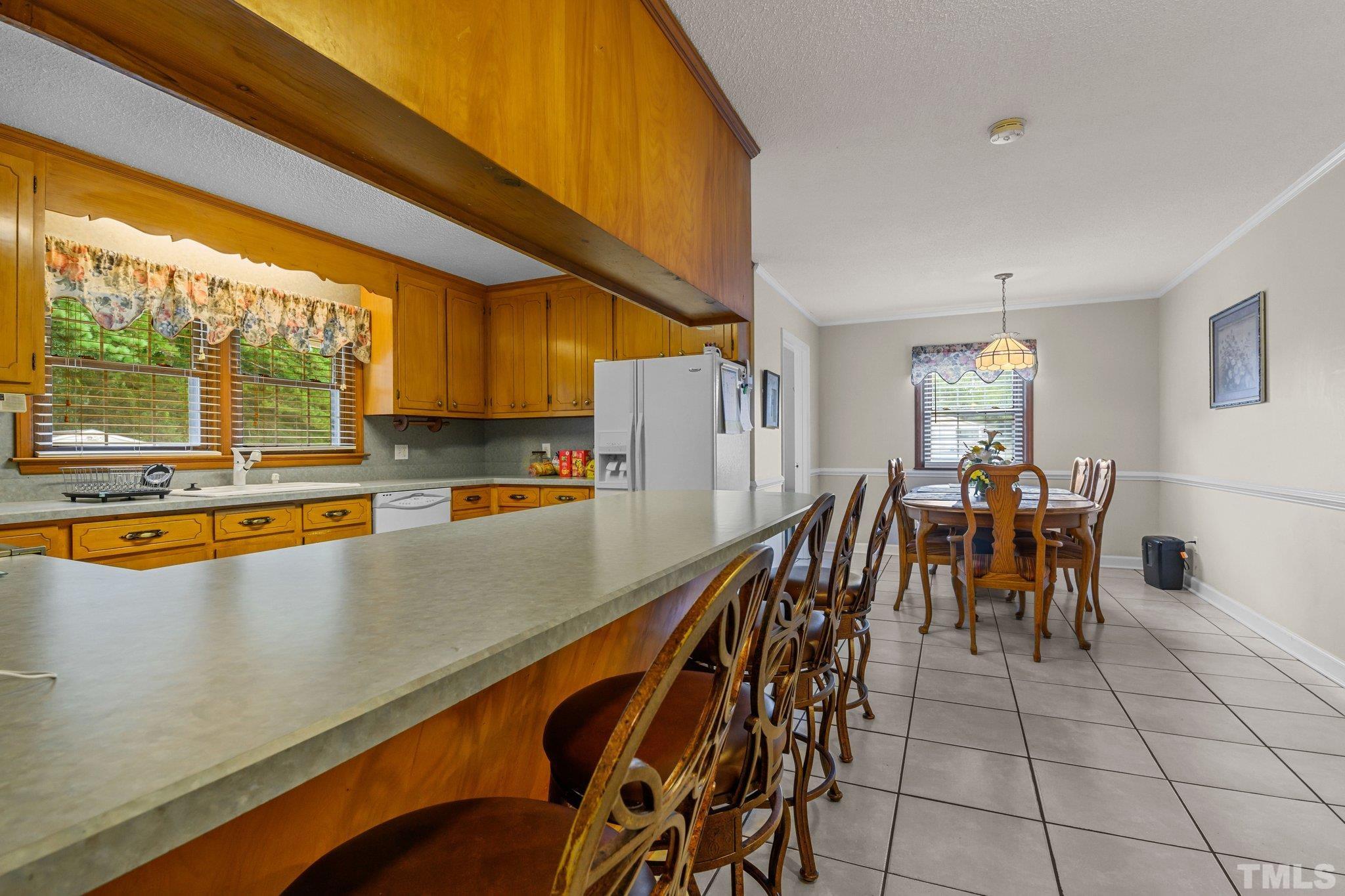 705 Sherron Road Durham, NC 27703 - Photo 26 of 28 a dining room with furniture and a floor to ceiling window