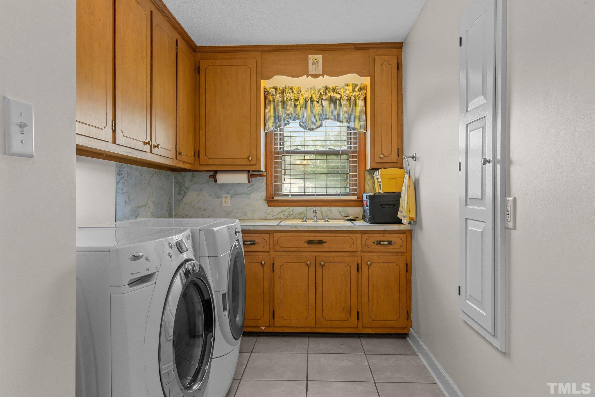 705 Sherron Road Durham, NC 27703 - Photo 27 of 28 a utility room with dryer and washer