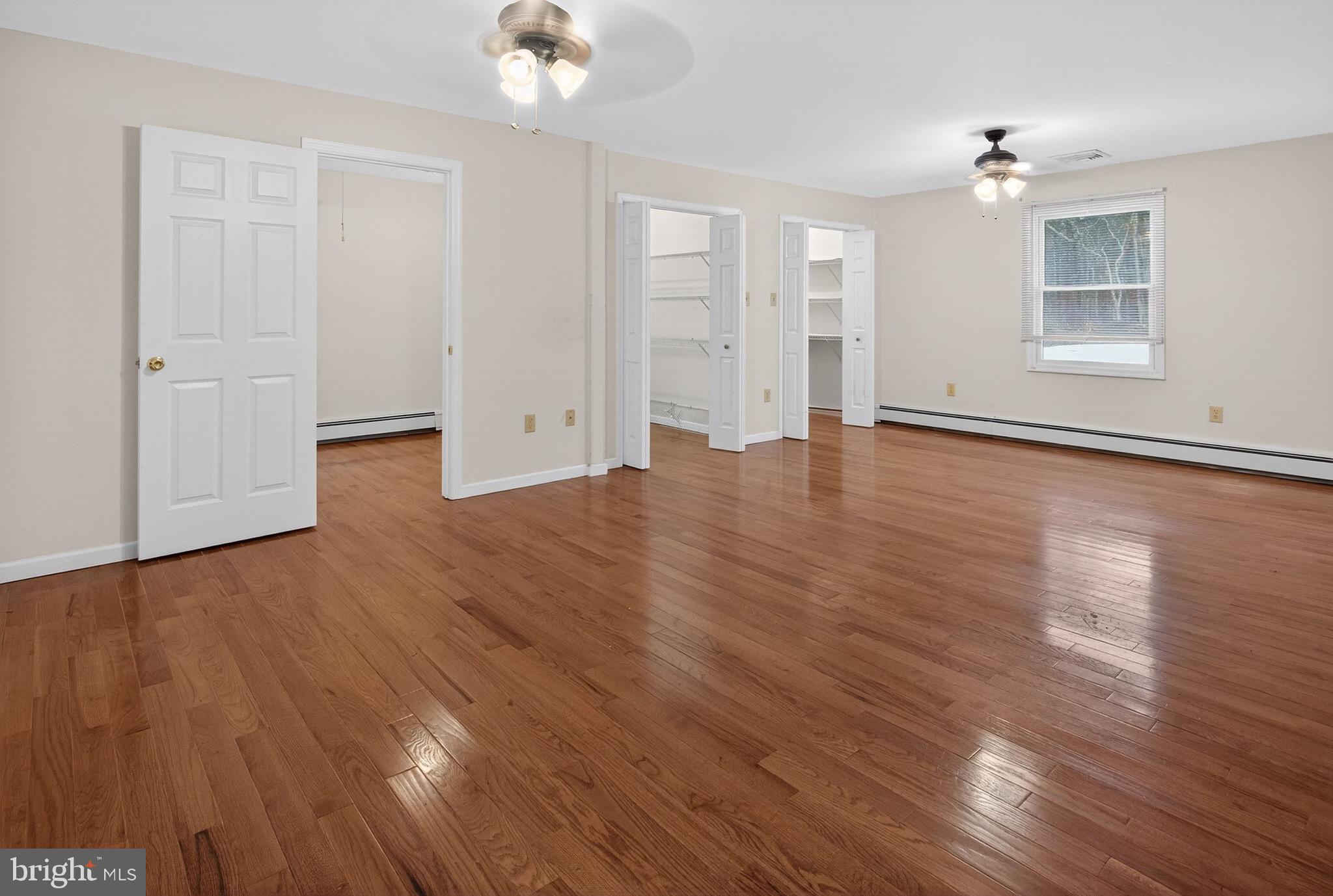 764 Lakehurst Road Browns Mills, NJ 08015 - Photo 14 of 36 a view of an empty room with wooden floor and a window