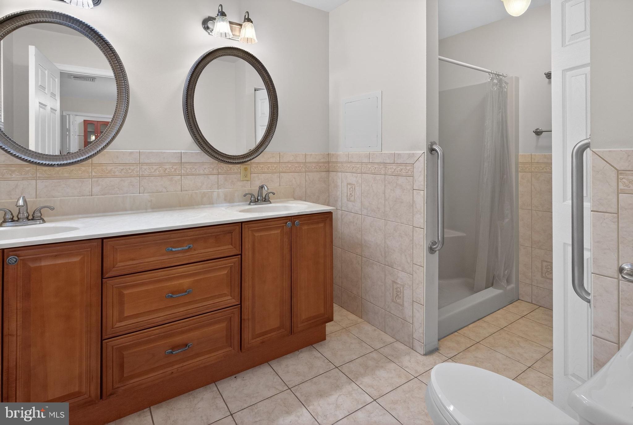 764 Lakehurst Road Browns Mills, NJ 08015 - Photo 16 of 36 a bathroom with a double vanity sink and a mirror