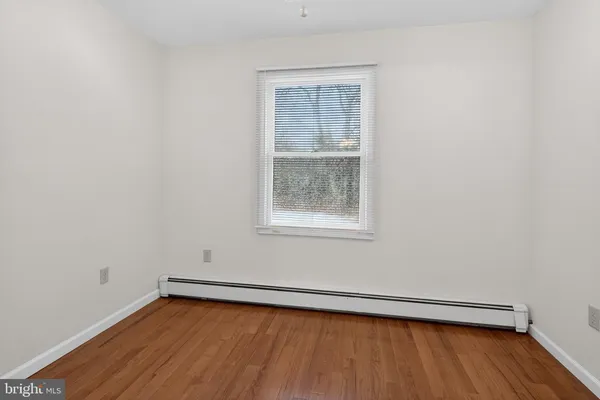 a view of a room with wooden floor and window