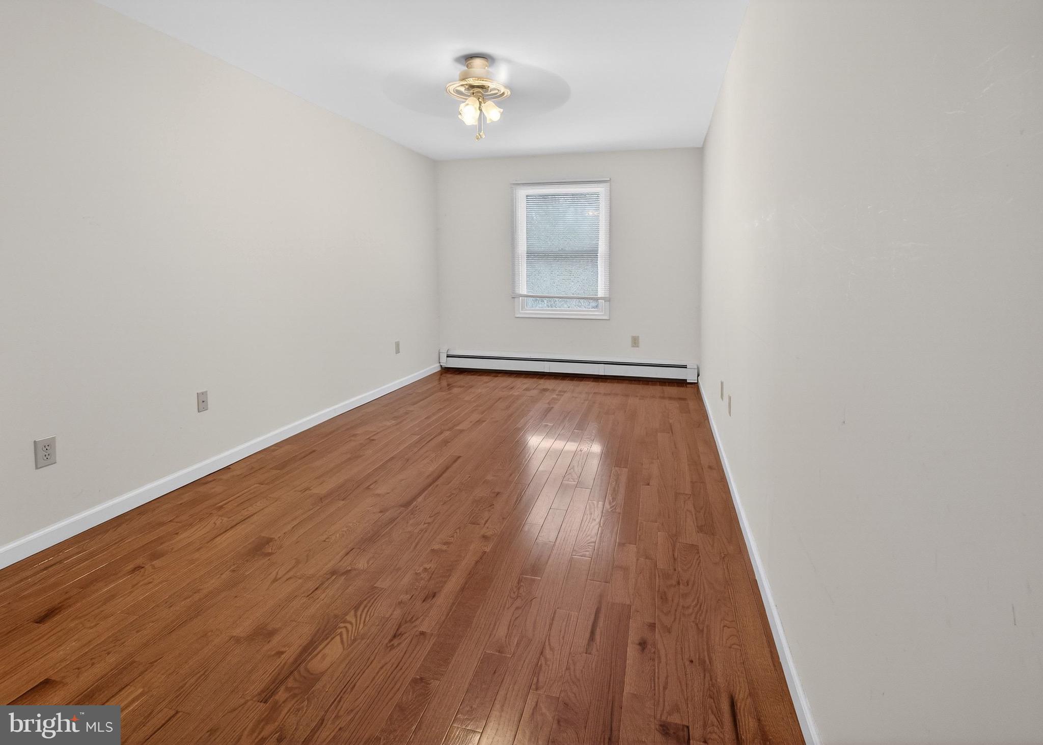 764 Lakehurst Road Browns Mills, NJ 08015 - Photo 22 of 36 a view of a room with wooden floor and ceiling fan