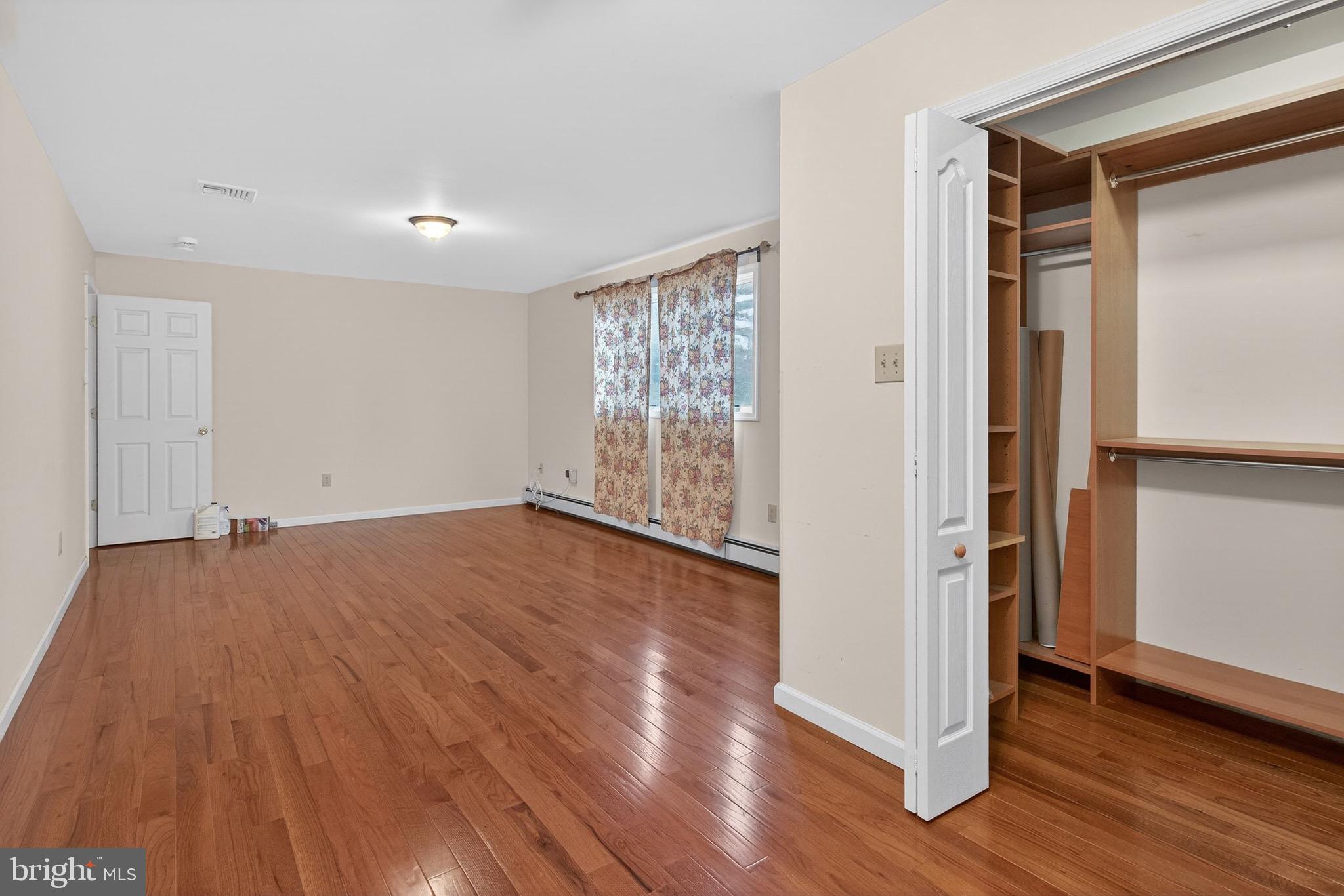 764 Lakehurst Road Browns Mills, NJ 08015 - Photo 26 of 36 an empty room with wooden floor & a window