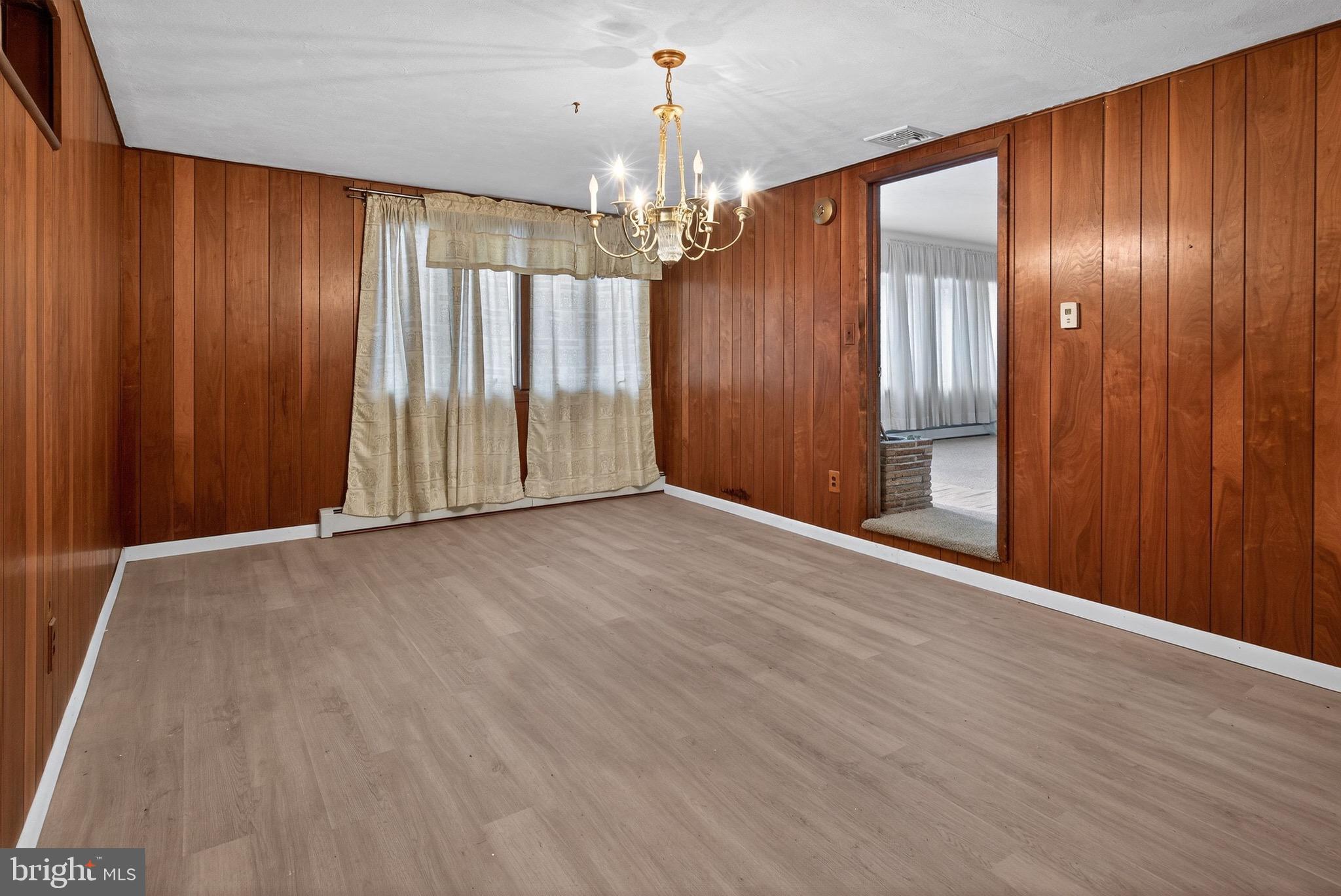764 Lakehurst Road Browns Mills, NJ 08015 - Photo 28 of 36 an empty room with wooden floor chandelier and closet