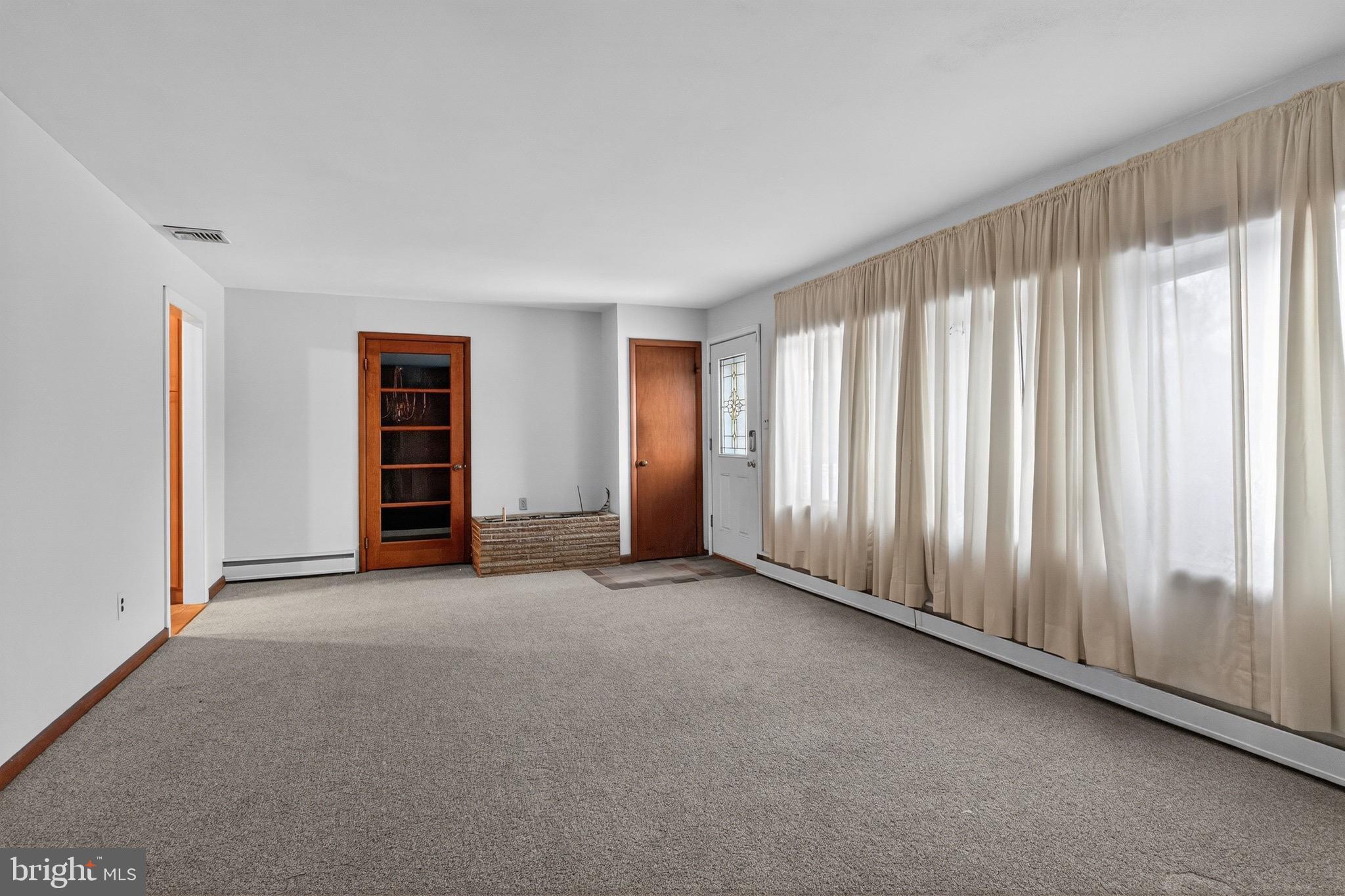 764 Lakehurst Road Browns Mills, NJ 08015 - Photo 4 of 36 an empty room with windows