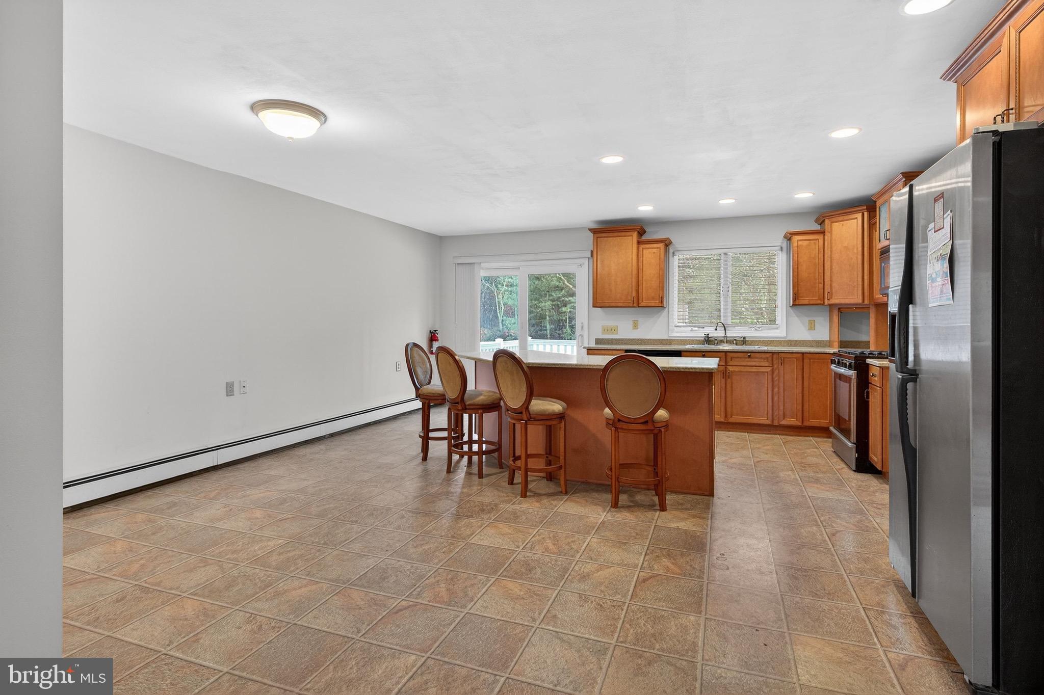 764 Lakehurst Road Browns Mills, NJ 08015 - Photo 9 of 36 a open kitchen with stainless steel appliances granite countertop a sink and a refrigerator