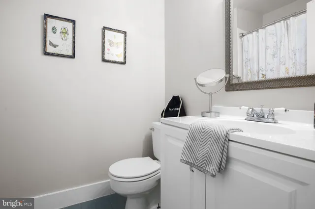a white toilet sitting next to a bathroom sink