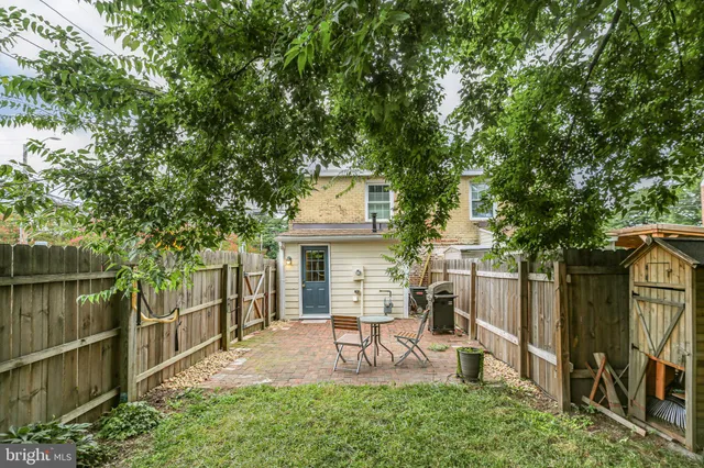 a view of a chairs and table in backyard of the house