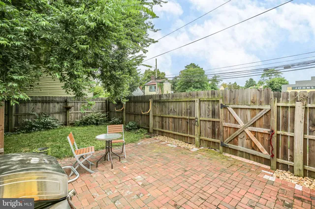 a view of a chair and table in backyard