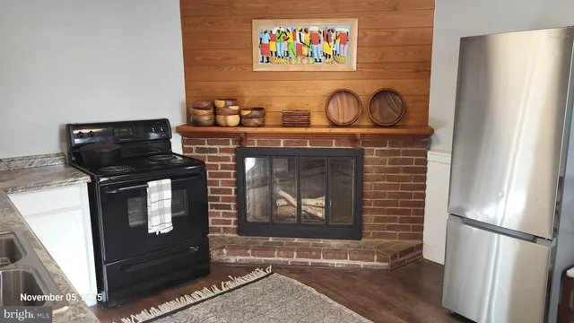 a kitchen with stainless steel appliances granite countertop a refrigerator and a stove