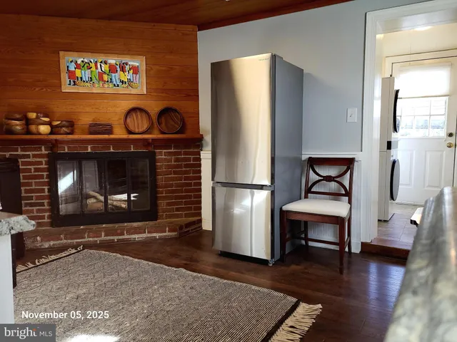 a view of a livingroom with furniture and a window