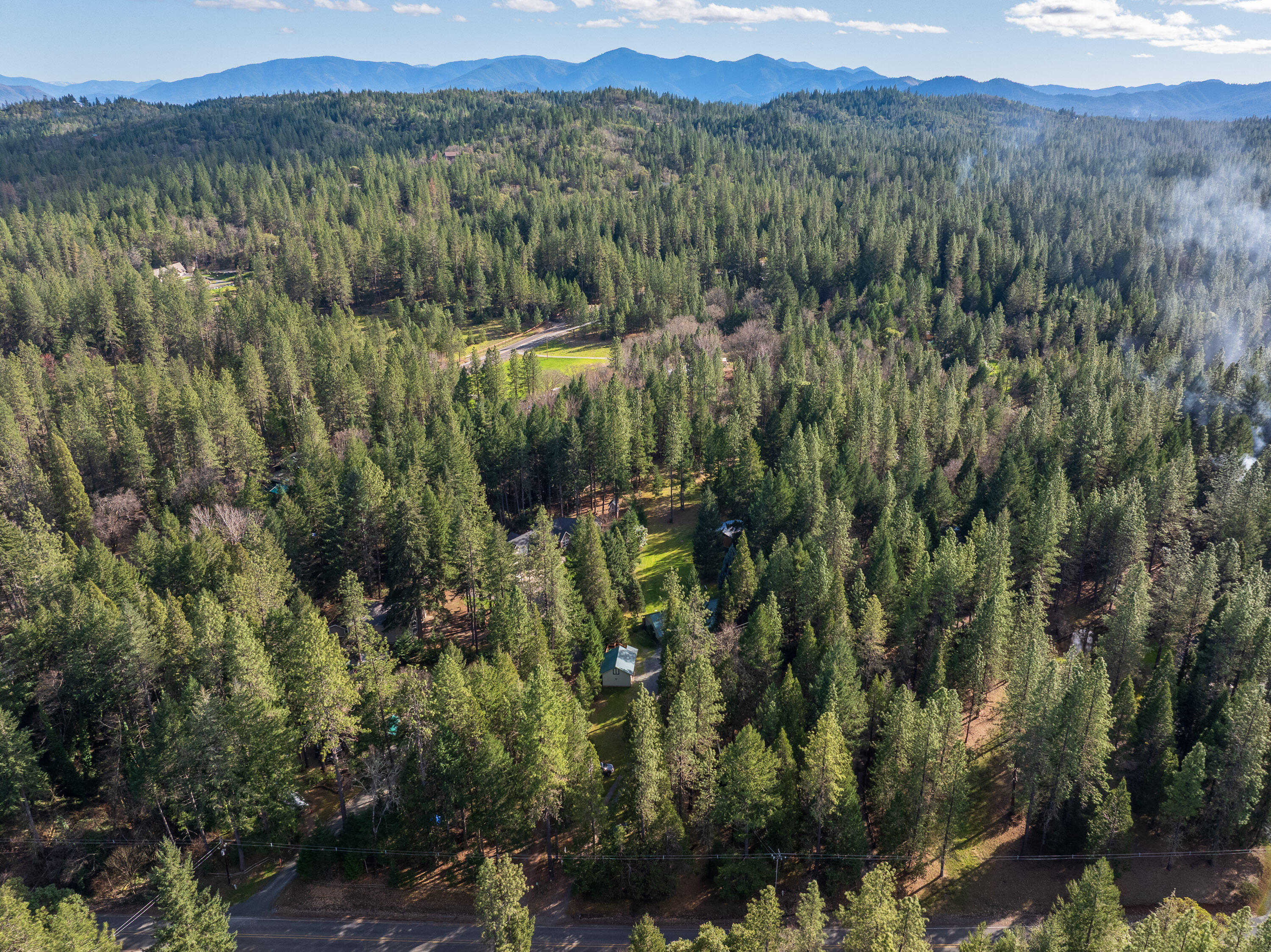 244 Riessen Road Grants Pass, OR 97526 - Photo 49 of 52 a view of a city with lush green forest