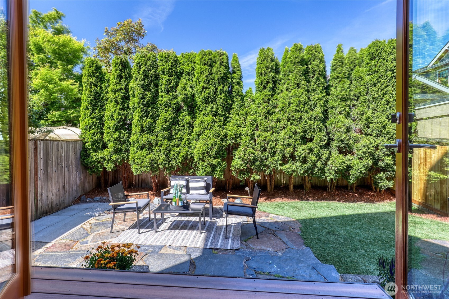 2334 North 57th Street Seattle, WA 98103 - Photo 11 of 27 a view of a chair and tables in the backyard