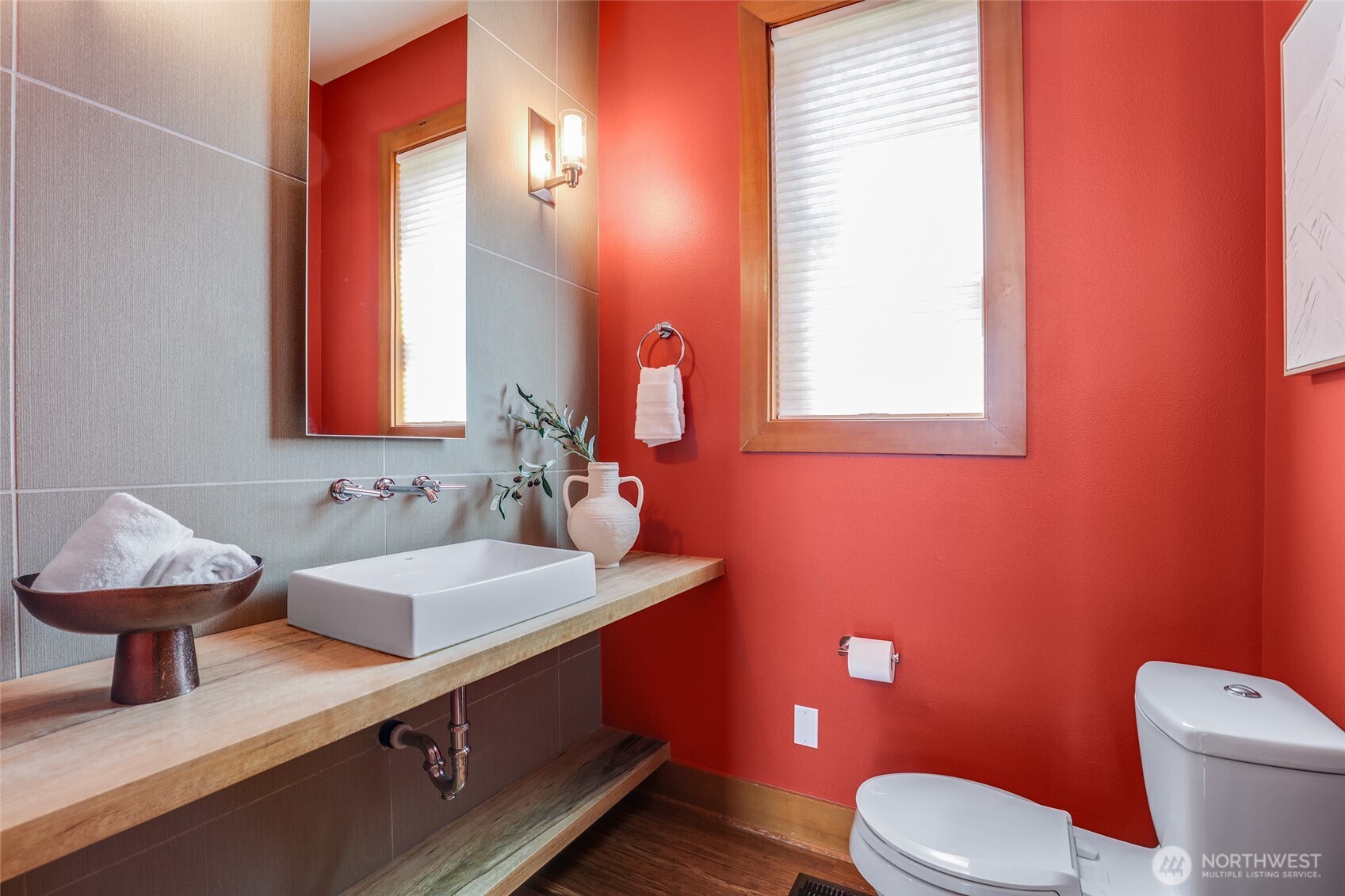 2334 North 57th Street Seattle, WA 98103 - Photo 13 of 27 a bathroom with a toilet sink and mirror