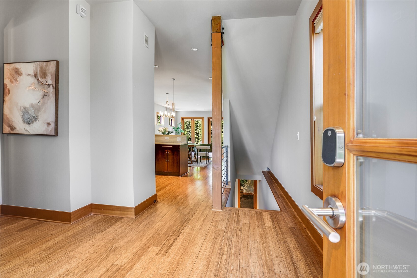 2334 North 57th Street Seattle, WA 98103 - Photo 2 of 27 a view of a hallway with wooden floor and staircase