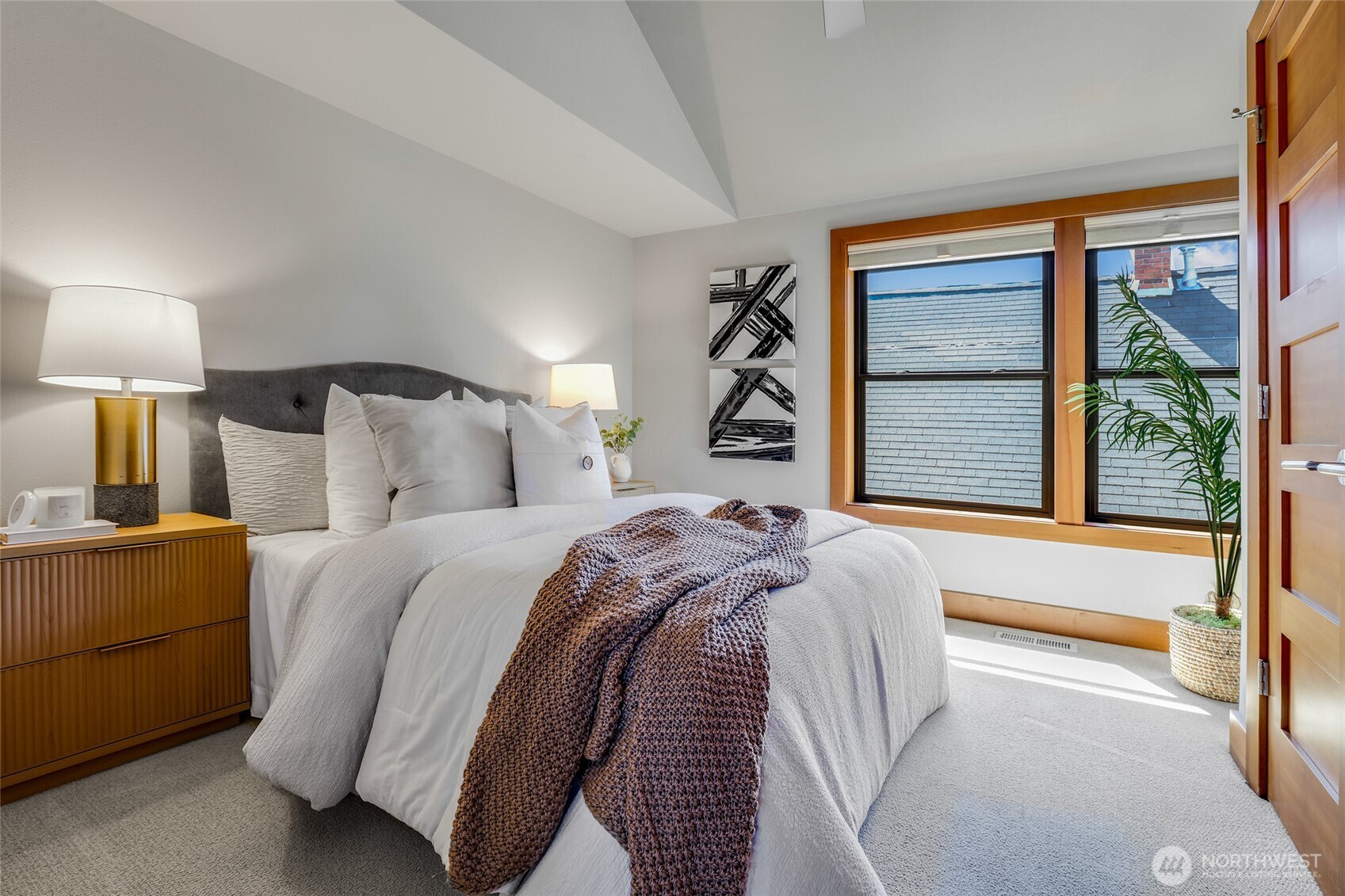 2334 North 57th Street Seattle, WA 98103 - Photo 21 of 27 a bed sitting in a bedroom next to a window