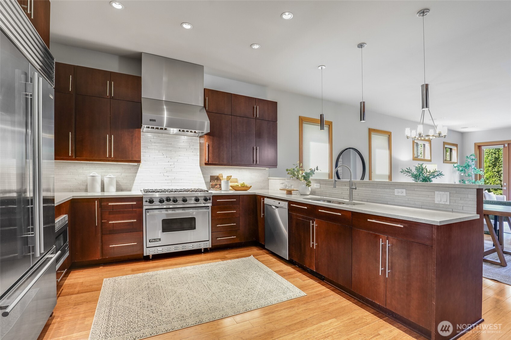 2334 North 57th Street Seattle, WA 98103 - Photo 3 of 27 a kitchen with stainless steel appliances granite countertop a stove top oven a sink and dishwasher