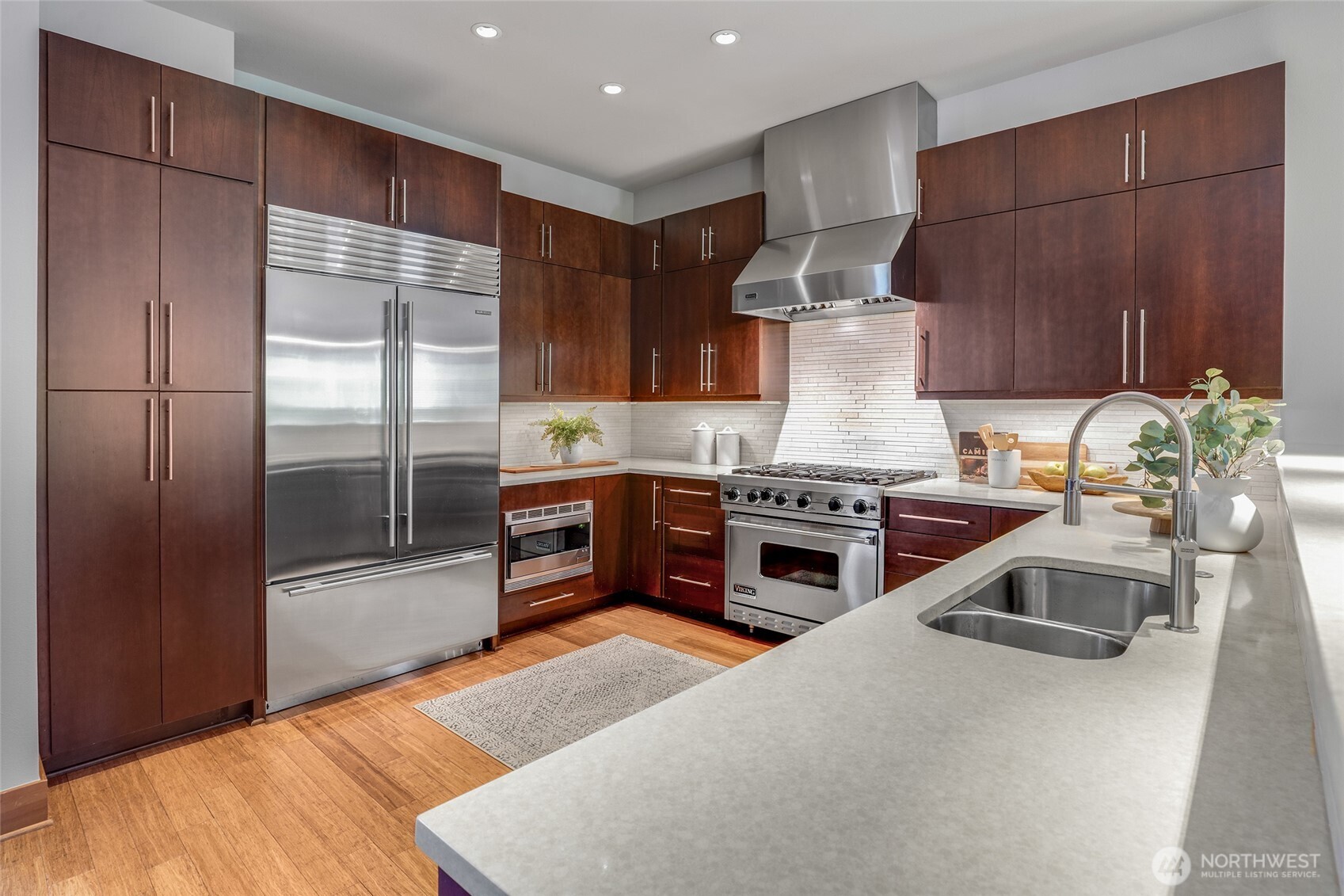 2334 North 57th Street Seattle, WA 98103 - Photo 4 of 27 a kitchen with stainless steel appliances granite countertop a stove refrigerator and cabinets